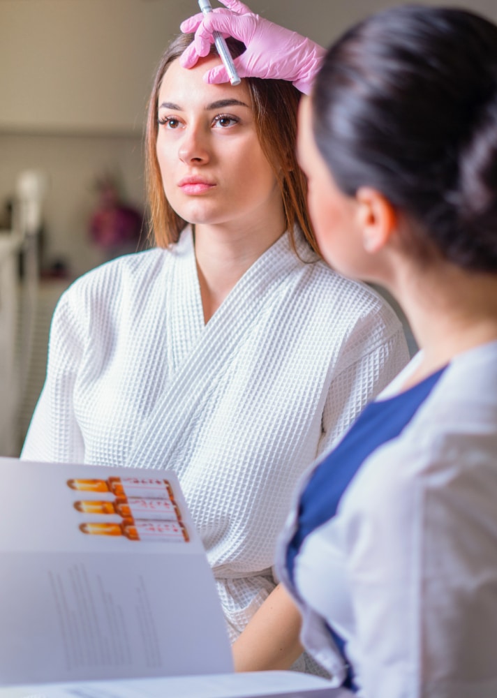 cosmetologist ready paint lines with marker patient face